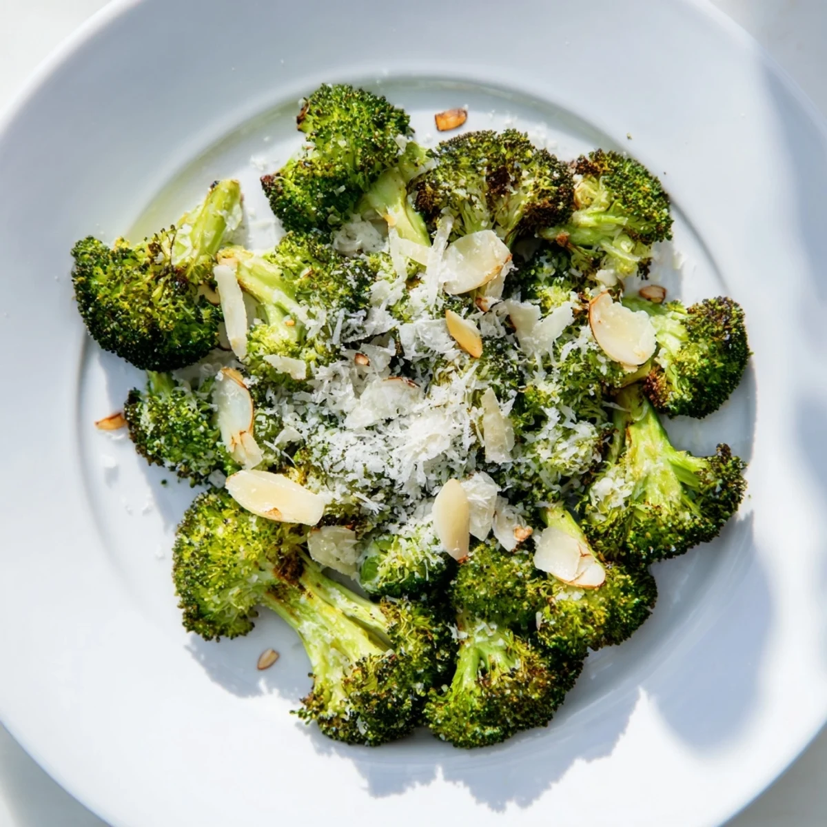 Golden-brown roasted broccoli with garlic and Parmesan, served fresh from the oven on a rustic platter.