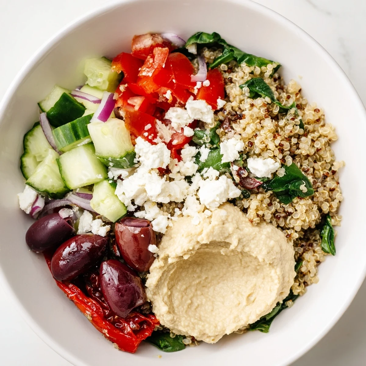 Freshly prepared Mediterranean Quinoa Bowl garnished with parsley, showcasing a wholesome and appetizing vegetarian meal.