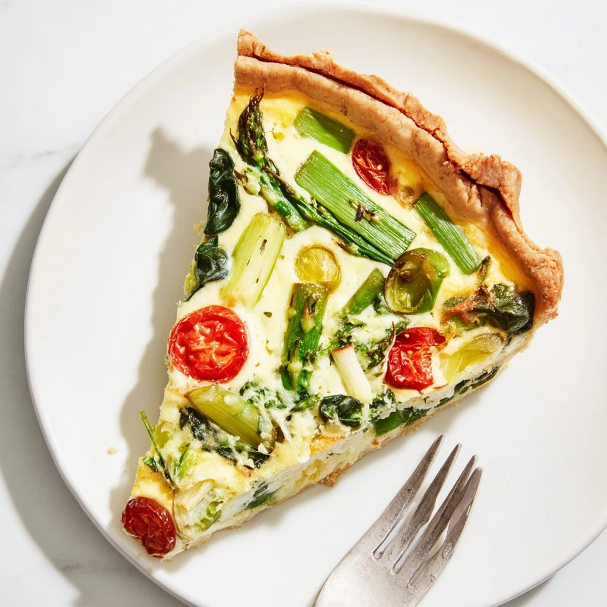 Freshly baked Spring Vegetable Quiche with Crust showcases flaky pastry and vibrant asparagus in a golden custard.