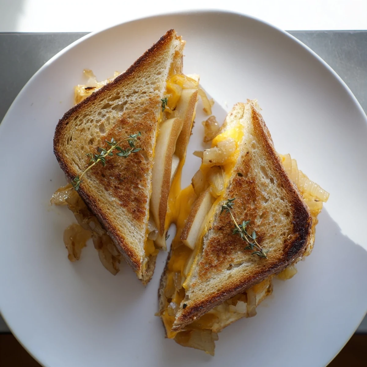 A close-up of the open-faced Pear, Apple & Graved Cheese with Caramelized Onions, featuring thin pear and apple slices on crispy buttered sourdough.
