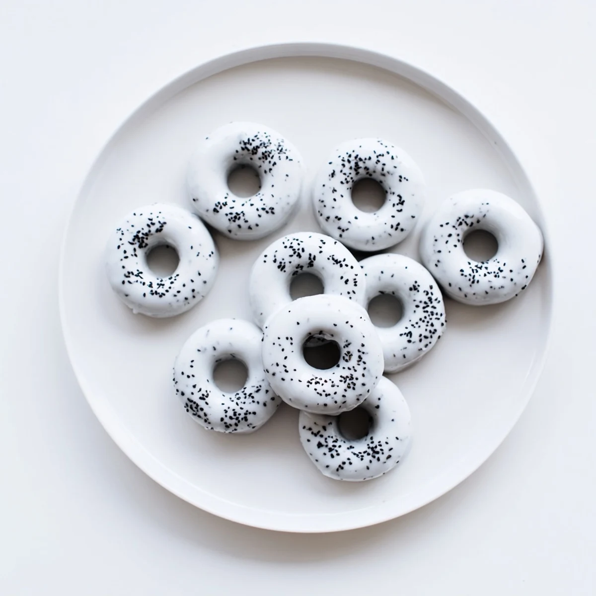 Warm Black Sesame Mochi Donuts cooling on a wire rack, showcasing their golden-brown edges and chewy texture against a cozy kitchen backdrop.