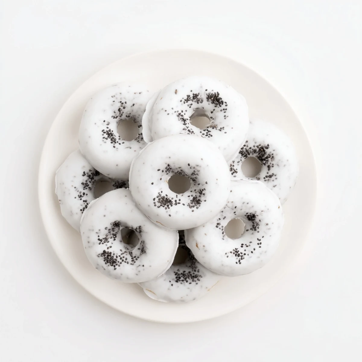 Sweet Black Sesame Mochi Donuts are displayed on a white plate, perfect for pairing with a hot cup of green tea in the afternoon.