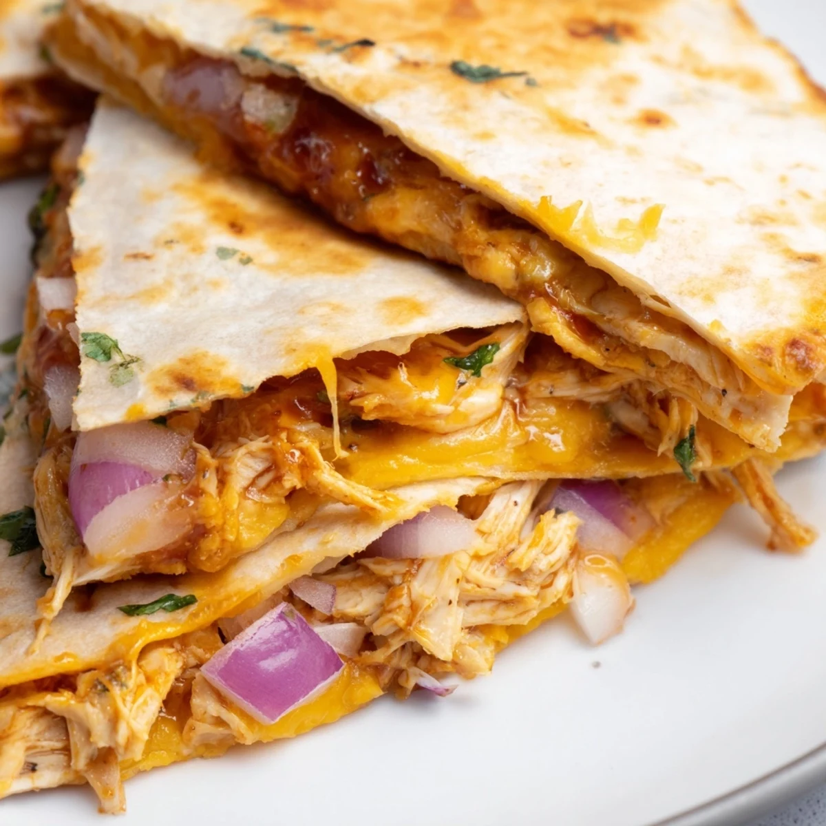 Golden brown flour tortilla stuffed with shredded hot honey BBQ chicken, melty mozzarella and cheddar cheese, with a side of sour cream and lime.