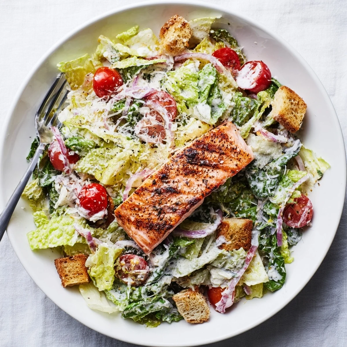 Succulent seasoned salmon over crunchy romaine lettuce tossed with tangy Caesar dressing and golden croutons.
