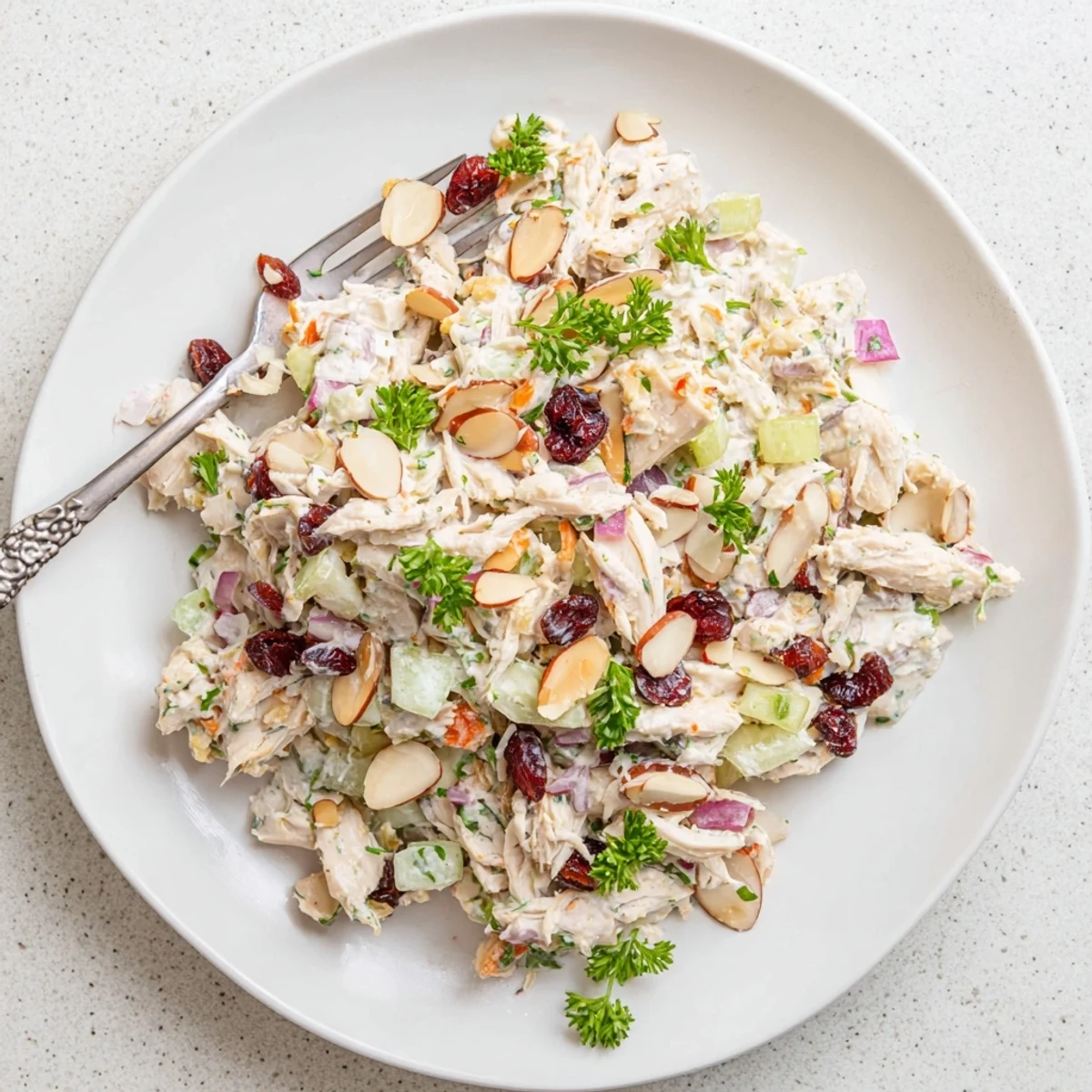 Healthy Greek yogurt rotisserie chicken salad featuring tender shredded chicken and colorful diced vegetables