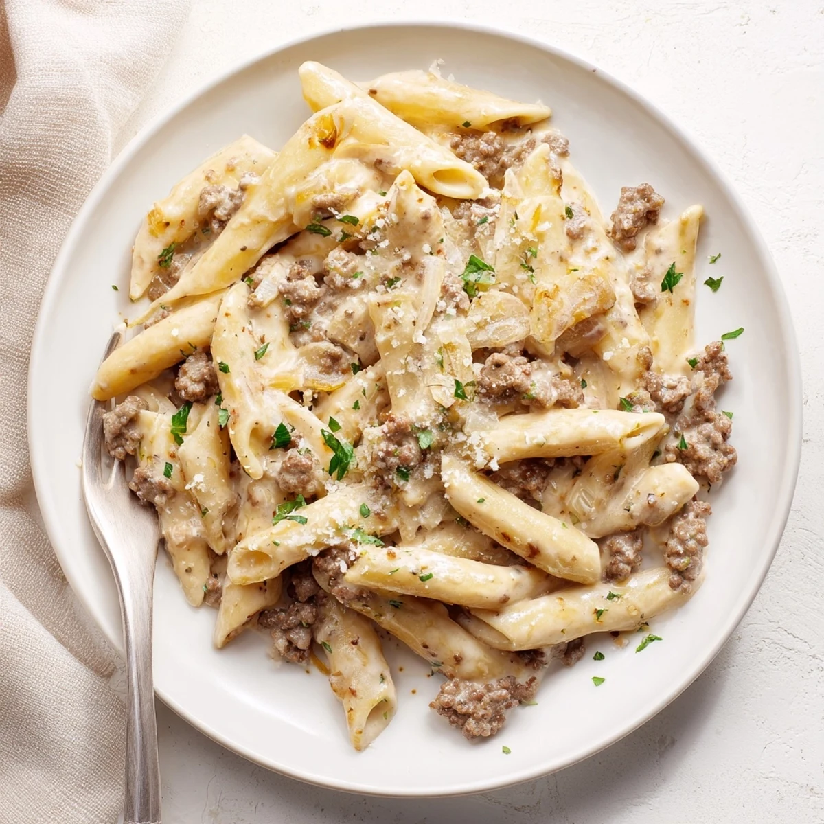 Hearty creamy beef pasta dish featuring tender ground beef and al dente fusilli noodles