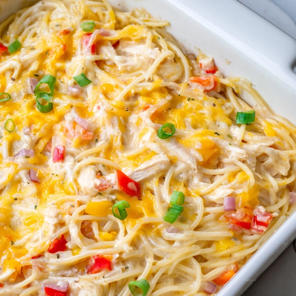 Creamy Monterey Jack cheese sauce coats tender spaghetti and juicy chicken pieces in this comforting baked pasta dish