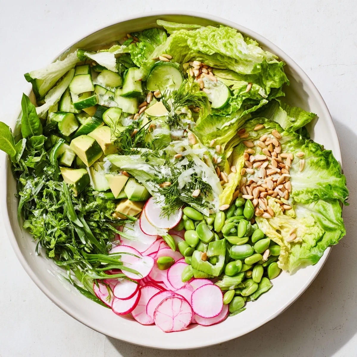 Colorful Green Goddess salad featuring crunchy snap peas, radishes, and creamy herb dressing