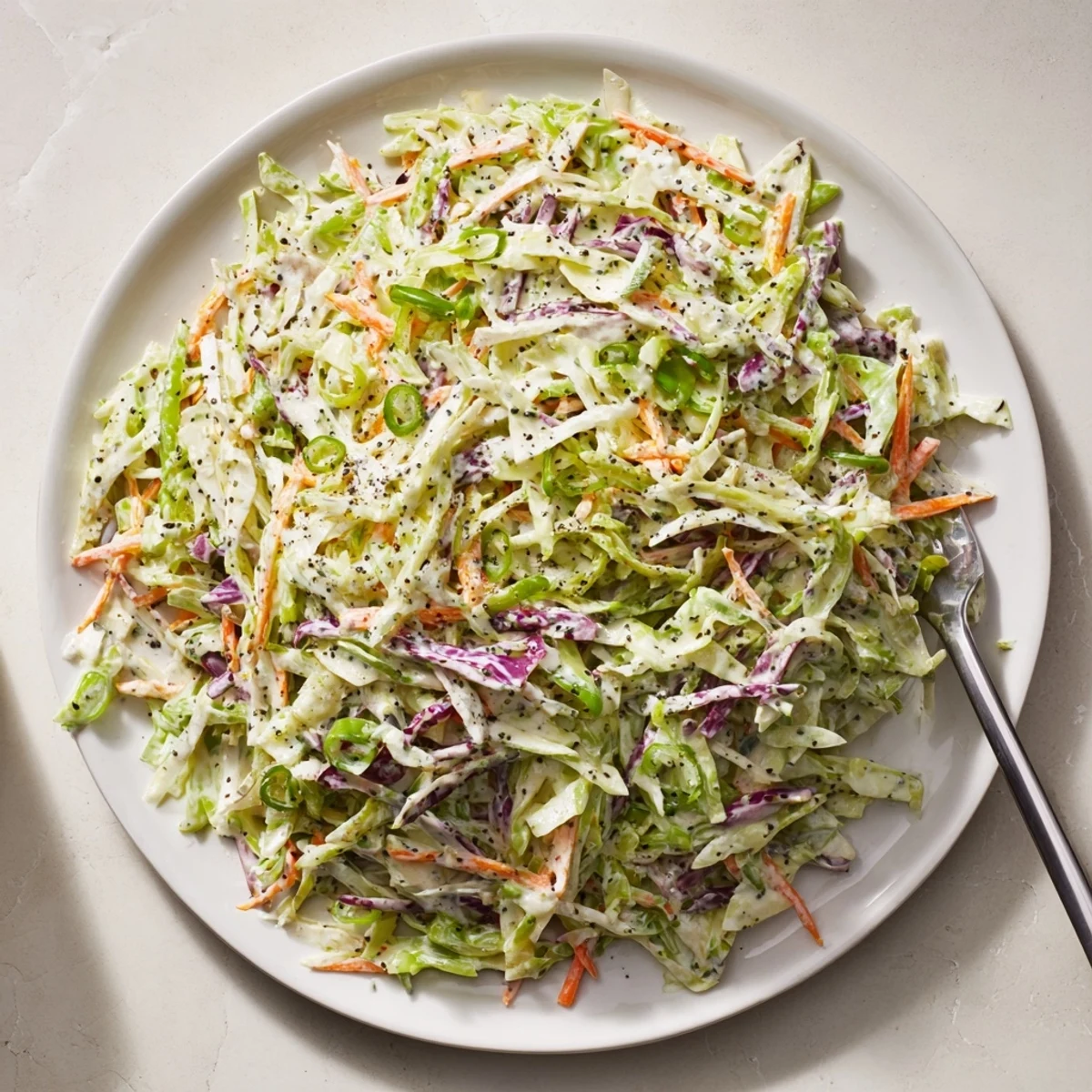 Creamy coleslaw salad with crisp colorful cabbage and carrots coated in a rich mayonnaise-based dressing