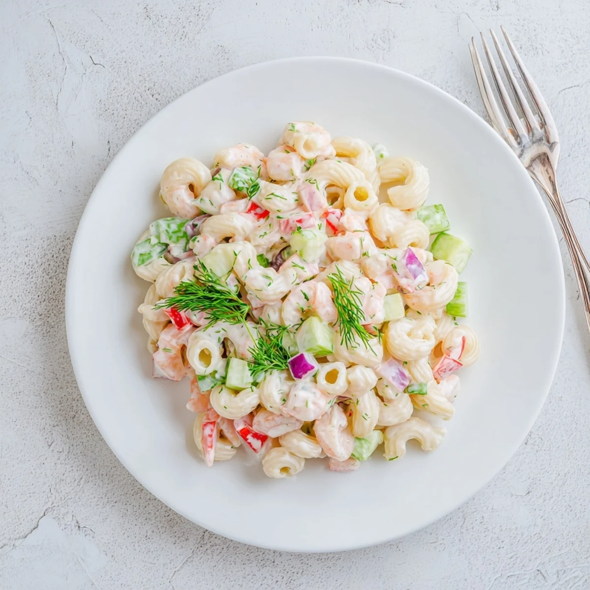 Creamy shrimp pasta salad with tender shrimp, colorful vegetables, and tangy dressing