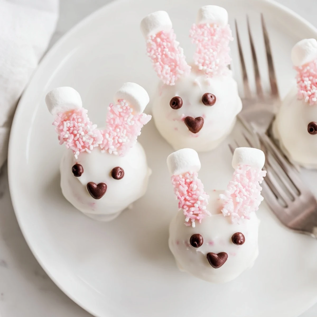 Bunny Oreo balls dipped in smooth white chocolate with pink marshmallow ears and chocolate chip eyes