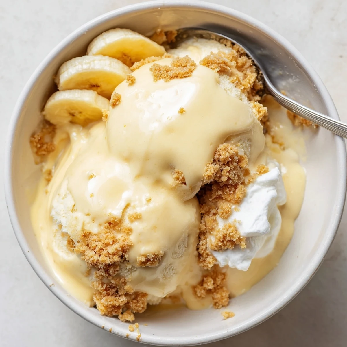 Homemade Ninja Creami Banana Cream Pie Ice Cream, silky texture, garnished with banana slices.