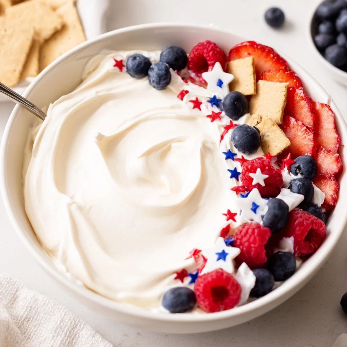 Chilled, fluffy dip with crackers — How To Make Star Spangled Cheesecake Dip.