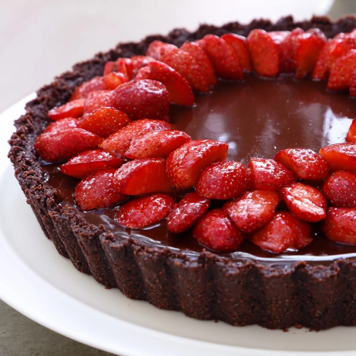 Dark Chocolate Strawberry Tart recipe: glossy ganache, juicy halved strawberries, chilled slice