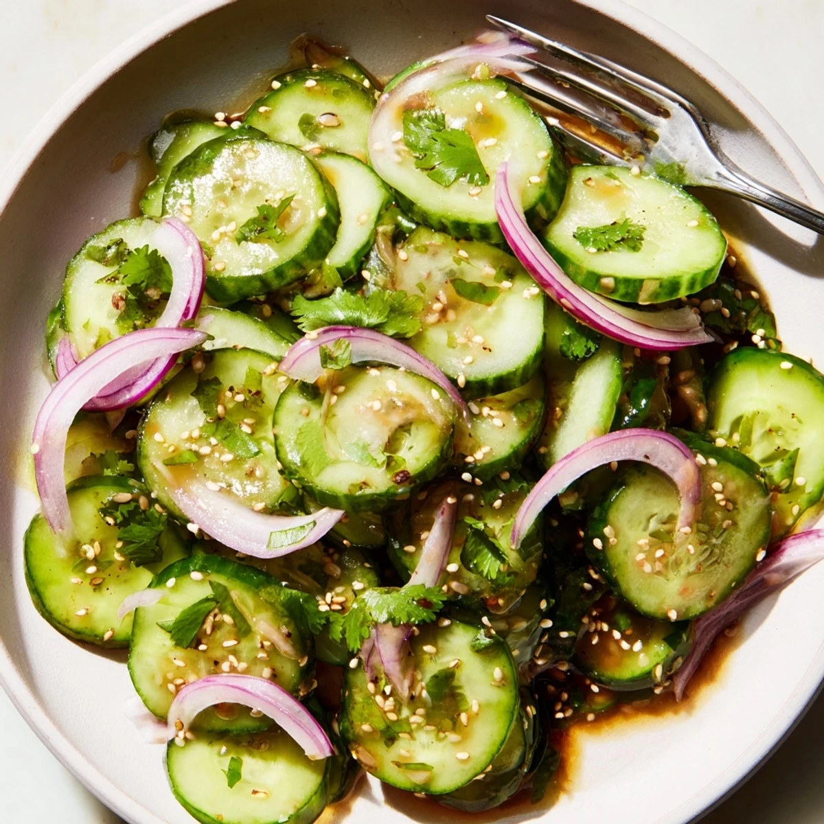 Bright green cucumber salad tossed with cilantro and red onion in sweet lime vinaigrette