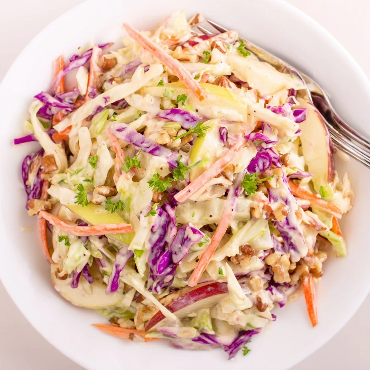 Chilled Apple Coleslaw served as picnic side, crisp cabbage and sweet apples.