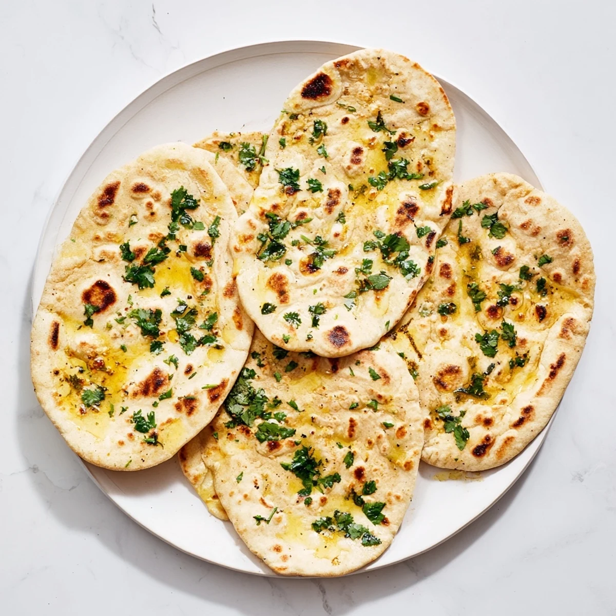 Warm sourdough discard soft naan bread steaming with garlic butter garnish