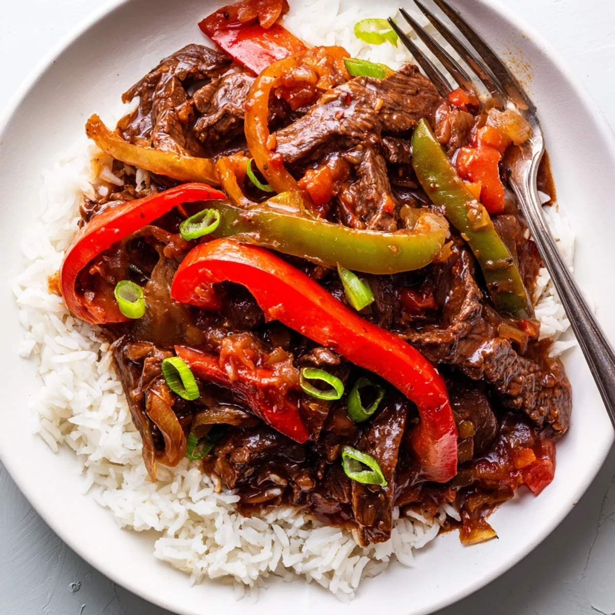 Slow Cooker Pepper Steak with tender beef strips and vibrant bell peppers in savory sauce