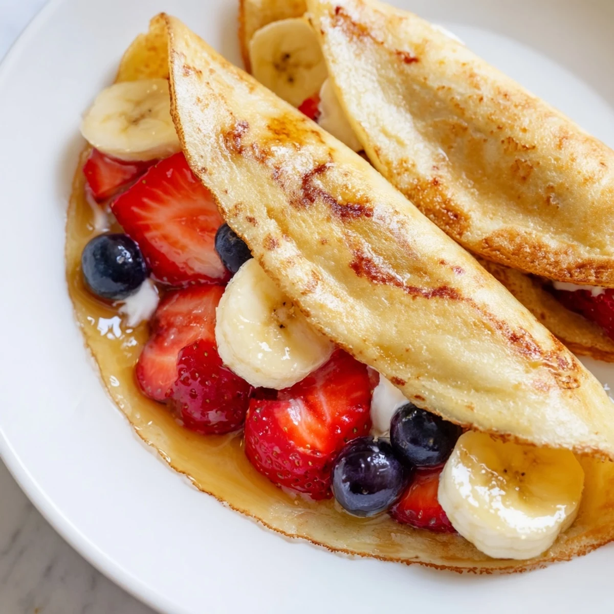 Soft pancake tacos topped with blueberries and creamy Greek yogurt
