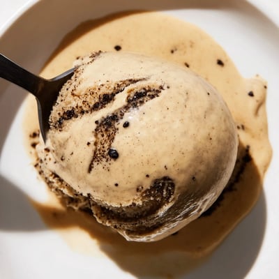 This scoop of homemade Vietnamese Coffee Ice Cream shows rich coffee swirls in a chilled ceramic dish, ready for an indulgent treat.